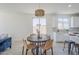 Bright eat-in kitchen features woven light fixture, neutral paint, and access to the kitchen at 2755 N 103Rd Ave, Avondale, AZ 85392