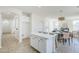 Bright kitchen boasts an island with white countertop and gold hardware, seamlessly flowing into the living area at 2755 N 103Rd Ave, Avondale, AZ 85392