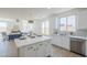 Bright kitchen with white cabinets, stainless steel appliances, and a view into the living room at 2755 N 103Rd Ave, Avondale, AZ 85392