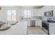 Stylish kitchen featuring white cabinets, stainless steel appliances, and ample counter space for cooking at 2755 N 103Rd Ave, Avondale, AZ 85392