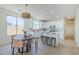 Eat-in kitchen features white cabinets, a center island, stainless appliances, and stylish woven lighting at 2755 N 103Rd Ave, Avondale, AZ 85392