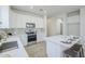 Modern kitchen with white cabinets, an island with barstool seating, and stainless steel appliances at 2755 N 103Rd Ave, Avondale, AZ 85392