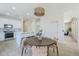 Bright eat-in kitchen features a tile floor, woven pendant light, and flows into living room at 2755 N 103Rd Ave, Avondale, AZ 85392