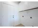 Laundry room with overhead cabinets, tile flooring, and access to the exterior at 2755 N 103Rd Ave, Avondale, AZ 85392