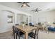 Open-concept living and dining area with modern ceiling fans and view of the archways at 2755 N 103Rd Ave, Avondale, AZ 85392