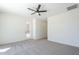 Light-filled bedroom featuring a ceiling fan and convenient access to the outdoor patio or backyard at 2755 N 103Rd Ave, Avondale, AZ 85392
