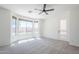 Airy bedroom with large bay windows providing backyard views, complemented by a modern ceiling fan at 2755 N 103Rd Ave, Avondale, AZ 85392