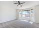 Spacious bedroom with large windows offering backyard views, enhanced by a ceiling fan for added comfort at 2755 N 103Rd Ave, Avondale, AZ 85392