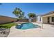Backyard in-ground pool features synthetic grass, rock landscape, storage shed and block wall fence at 2755 N 103Rd Ave, Avondale, AZ 85392