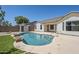 Backyard in-ground pool features synthetic grass, rock landscape, storage shed and home exterior at 2755 N 103Rd Ave, Avondale, AZ 85392