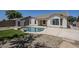 Backyard in-ground pool features synthetic grass, rock landscape, storage shed and home exterior at 2755 N 103Rd Ave, Avondale, AZ 85392