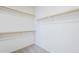 Organized walk-in closet featuring multiple wooden shelves and ample storage space for clothing and accessories at 2755 N 103Rd Ave, Avondale, AZ 85392