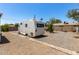 Gravel backyard with RV parking, enhanced by a paved walkway, showcasing outdoor potential at 2802 E Virginia Ave, Phoenix, AZ 85008