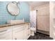 Stylish bathroom features a modern vanity, a decorative mirror, and a tiled shower at 2802 E Virginia Ave, Phoenix, AZ 85008
