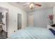 Bedroom with a ceiling fan, a mirror, tiled floors, and blue accents at 2802 E Virginia Ave, Phoenix, AZ 85008