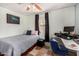 Cozy bedroom with a bed, desk, and window, perfect for relaxation and work at 2802 E Virginia Ave, Phoenix, AZ 85008