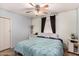 Comfortable bedroom with teal accents, tile floor, ceiling fan and a window for natural light at 2802 E Virginia Ave, Phoenix, AZ 85008