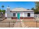 Charming home with red brick accents, white paint, gray roof and turquoise front door at 2802 E Virginia Ave, Phoenix, AZ 85008