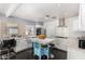 A well lit kitchen boasts white cabinets, stainless appliances, a center island and dark wood floors at 2802 E Virginia Ave, Phoenix, AZ 85008