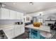 An open concept kitchen features a center island, stainless appliances, and breakfast bar seating at 2802 E Virginia Ave, Phoenix, AZ 85008