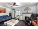 Cozy living room with fireplace, blue sofa, hardwood floors and large window at 2802 E Virginia Ave, Phoenix, AZ 85008