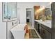Luxurious bathroom featuring a soaking tub, double sinks, and contemporary fixtures with modern finishes at 28349 N 113Th St, Scottsdale, AZ 85262