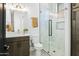 A half bathroom featuring a single sink, marble countertop, toilet, and enclosed shower at 28349 N 113Th St, Scottsdale, AZ 85262