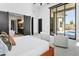 Spacious bedroom with access to the backyard pool, modern sliding doors, and a view of the ensuite bathroom at 28349 N 113Th St, Scottsdale, AZ 85262