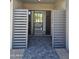 Modern home entryway featuring stone pavers, a decorative privacy gate, and a glimpse of the luxurious interior at 28349 N 113Th St, Scottsdale, AZ 85262