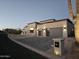 Contemporary home featuring a three-car garage, neutral colors, desert landscaping, and a paved driveway at 28349 N 113Th St, Scottsdale, AZ 85262