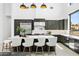 Elegant kitchen featuring a large island with seating, stainless steel appliances, and dark cabinetry for a modern touch at 28349 N 113Th St, Scottsdale, AZ 85262