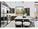 Bright, modern kitchen features a large island with seating, stainless steel appliances, and scenic mountain views at 28349 N 113Th St, Scottsdale, AZ 85262
