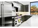Close-up of a modern kitchen with stainless steel appliances, granite countertops, and sleek, dark cabinets at 28349 N 113Th St, Scottsdale, AZ 85262