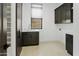 Functional laundry room features modern cabinetry, a sink, and ample storage space at 28349 N 113Th St, Scottsdale, AZ 85262