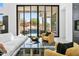 Inviting living room with a stylish black-and-white rug and comfortable seating, showcasing serene outdoor views and a pool at 28349 N 113Th St, Scottsdale, AZ 85262