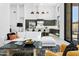 Expansive living area with white furniture, black accents, high ceilings, and a view into the adjacent modern kitchen at 28349 N 113Th St, Scottsdale, AZ 85262