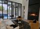 Living room featuring fireplace, modern furniture, and sliding glass doors leading to the pool and patio at 28349 N 113Th St, Scottsdale, AZ 85262