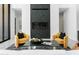 Cozy living room with a modern fireplace and comfortable armchairs, showcasing sleek design and a relaxing atmosphere at 28349 N 113Th St, Scottsdale, AZ 85262