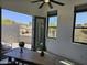 Bright home office featuring a ceiling fan, two windows, and an open door leading to an outdoor patio at 28349 N 113Th St, Scottsdale, AZ 85262