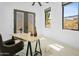 Bright home office features a sleek desk, decor, and views of the surrounding desert landscape at 28349 N 113Th St, Scottsdale, AZ 85262
