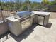 An outdoor kitchen featuring stainless steel appliances and a built-in barbeque grill, situated on a tiled patio at 28349 N 113Th St, Scottsdale, AZ 85262