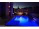 Backyard swimming pool with a waterfall feature and lounge area, perfect for evening relaxation at 28349 N 113Th St, Scottsdale, AZ 85262