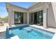 Backyard pool with integrated water feature and travertine tile at 28349 N 113Th St, Scottsdale, AZ 85262