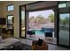 View of backyard pool and covered patio through sliding glass doors at 28349 N 113Th St, Scottsdale, AZ 85262