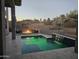 Tranquil pool area with a waterfall feature and cozy fire pit setting at 28349 N 113Th St, Scottsdale, AZ 85262