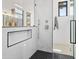 Modern shower with white marble walls, black hexagon tile flooring, and a built-in shower niche at 28349 N 113Th St, Scottsdale, AZ 85262