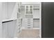 Spacious walk-in closet with custom white shelving and drawers for ample storage and organization at 28349 N 113Th St, Scottsdale, AZ 85262