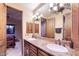 Bathroom featuring double vanity sinks with granite countertops and stylish fixtures at 31721 N 138Th Pl, Scottsdale, AZ 85262