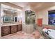 Beautiful bathroom featuring double sinks, a soaking tub, and a glass-enclosed shower at 31721 N 138Th Pl, Scottsdale, AZ 85262