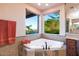 Inviting bathtub with dual windows offering scenic outdoor views at 31721 N 138Th Pl, Scottsdale, AZ 85262